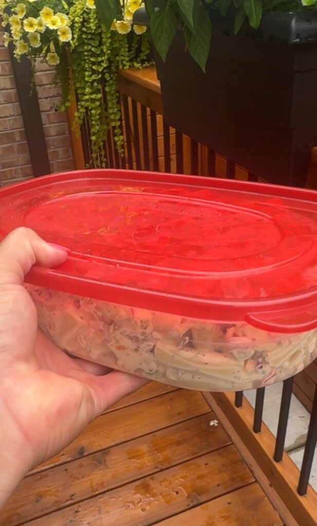 The macaroni salad in a red lid tupperware