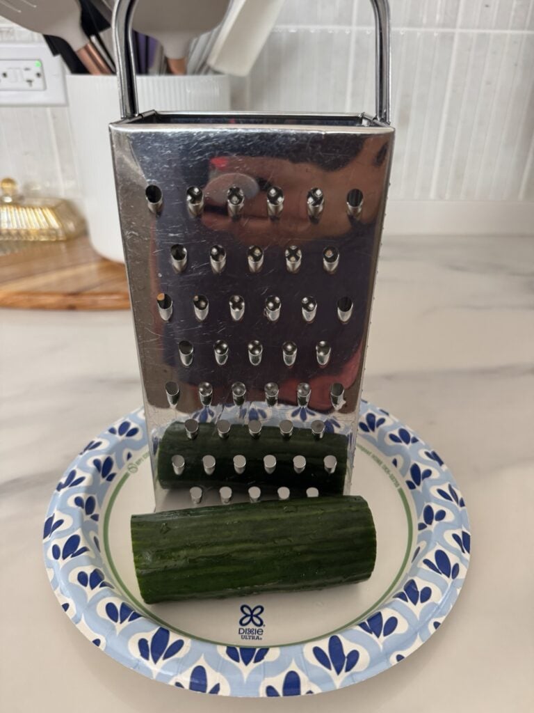 A cheese grater and cucumber