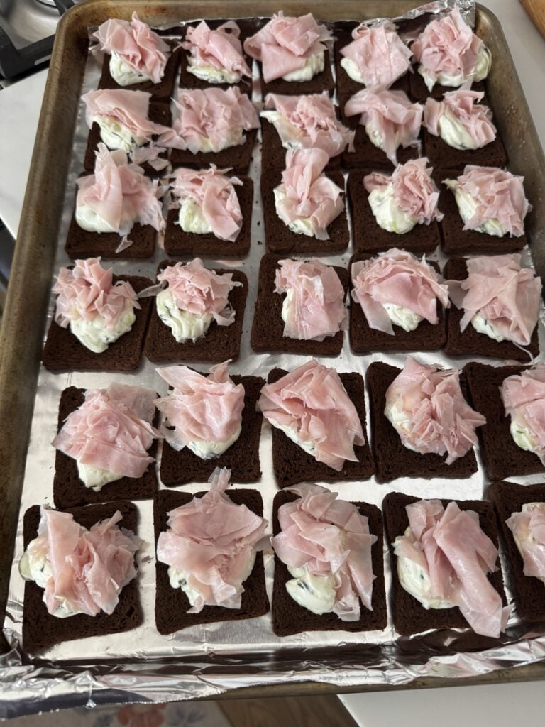 Shaved ham on top of cucumber cream cheese toasts