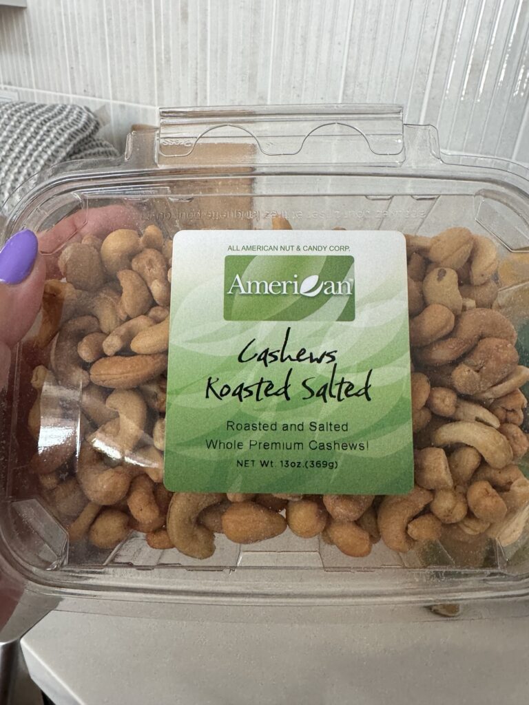 A container of roasted and salted cashews