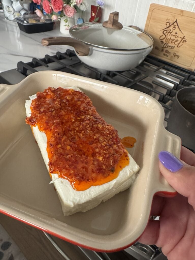 A brick of cream cheese with chili onion crunch