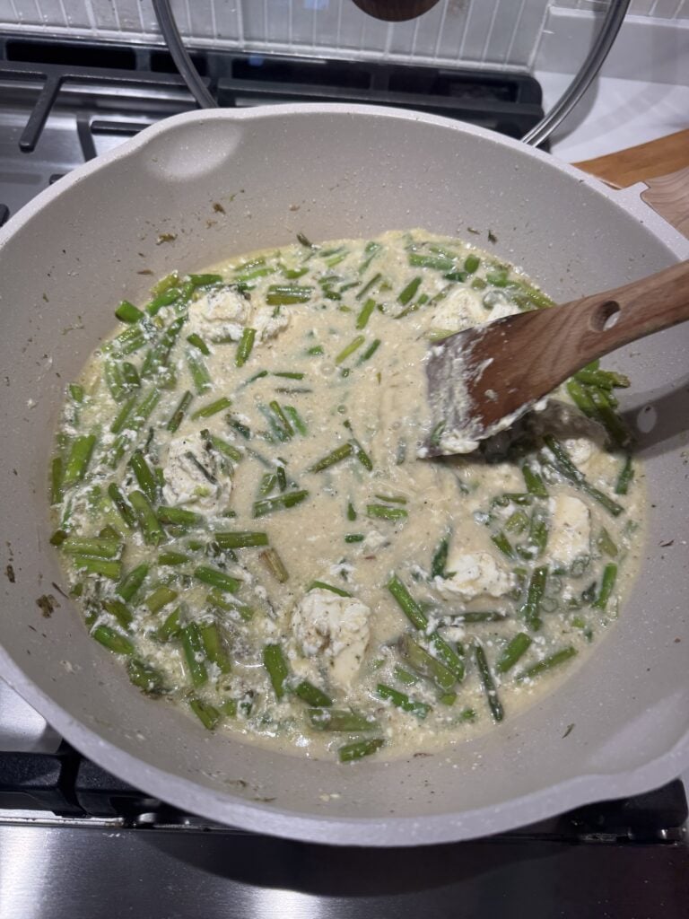 Asparagus cooking in creamy sauce