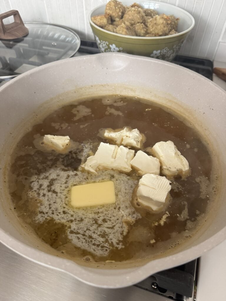 Butter, cream cheese, and broth simmering in the pan
