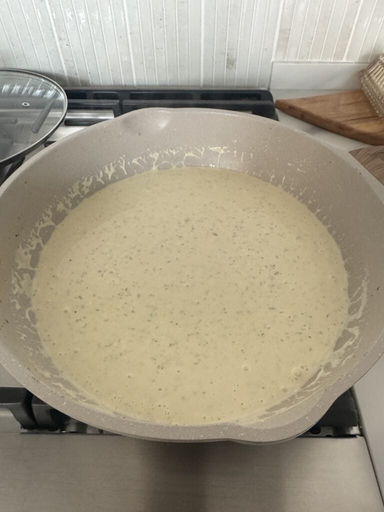 The creamy sauce in the pan