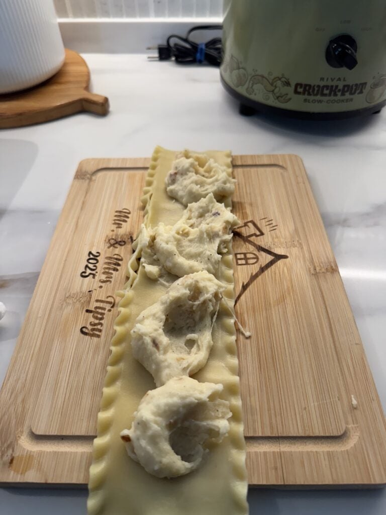 Potato filling spread on a lasagna noodle