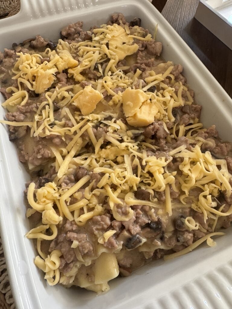 The pierogi lasagna topped with cheese before going in the oven