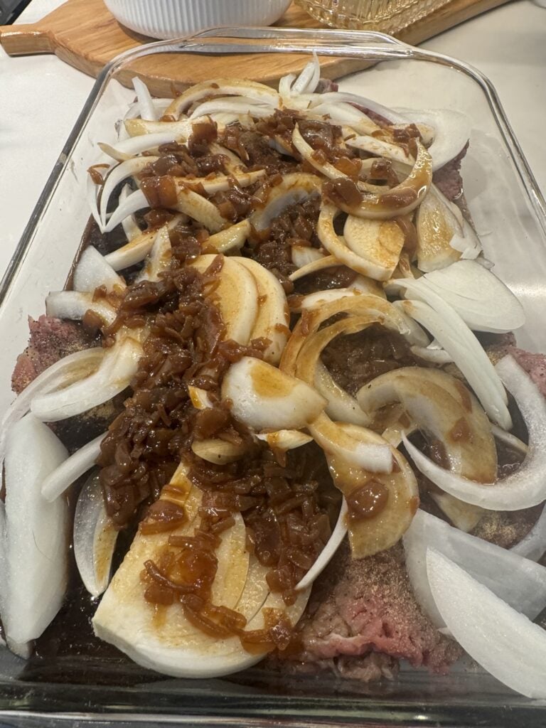The cube steak with onions before baking
