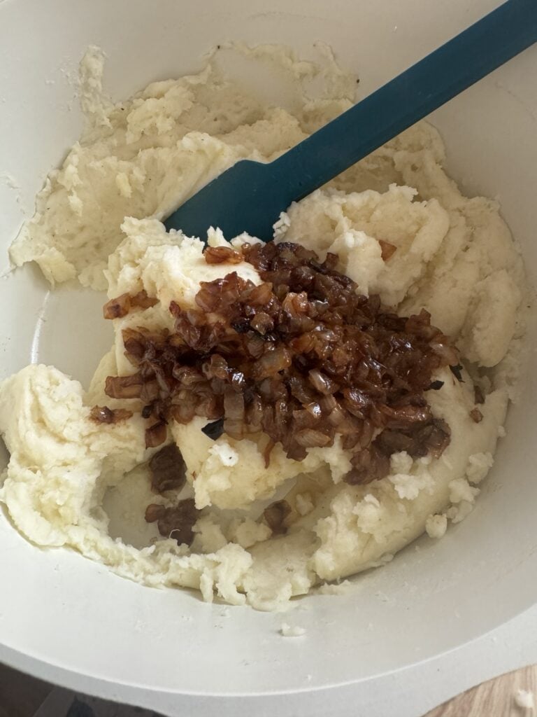 Cooked onions in the potato mixture