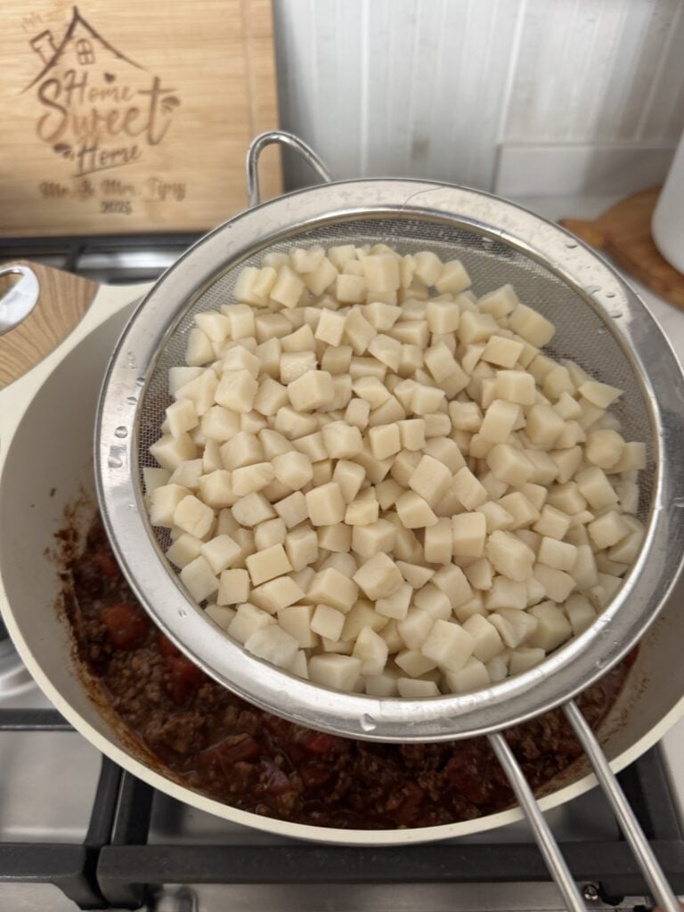 Diced potatoes in a strainer