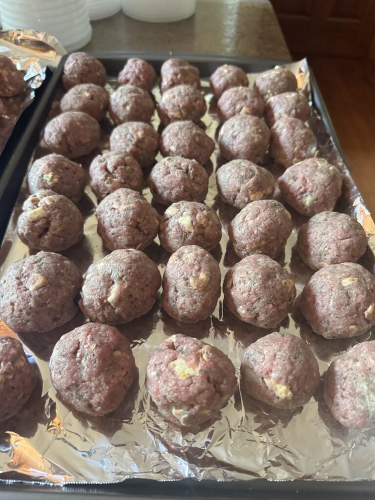 Meatballs on a baking sheet before being cooked