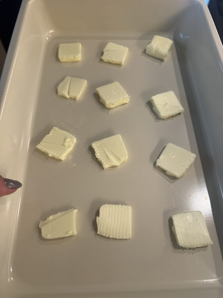 Pats of butter in a baking dish