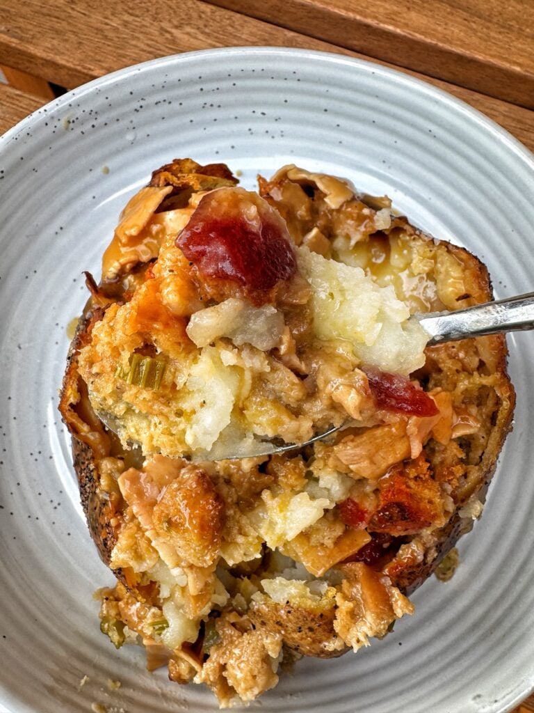 A spoonful of the potato with all the toppings