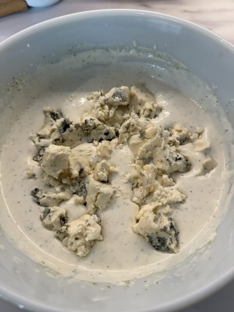 Chunks of blue cheese in dressing