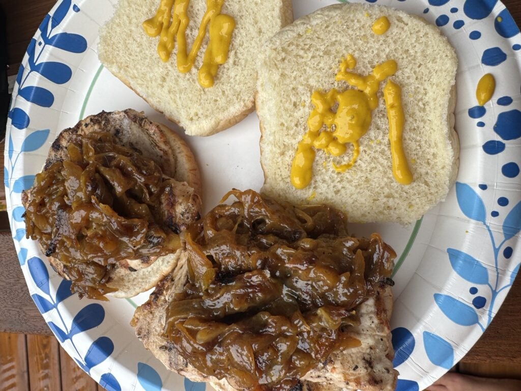 The finished sandwiches, shown open with mustard on the top buns
