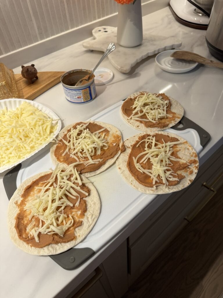 Soft tacos with refried beans and shredded cheese
