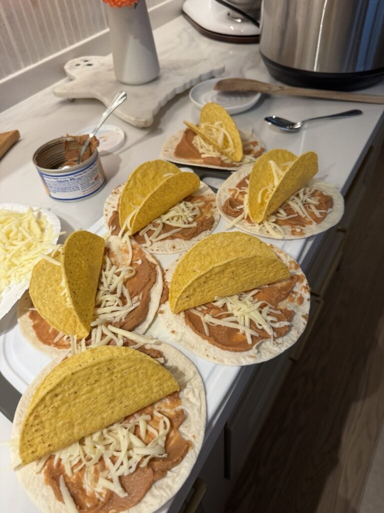 The soft tacos with cheese and beans with hard shells on top