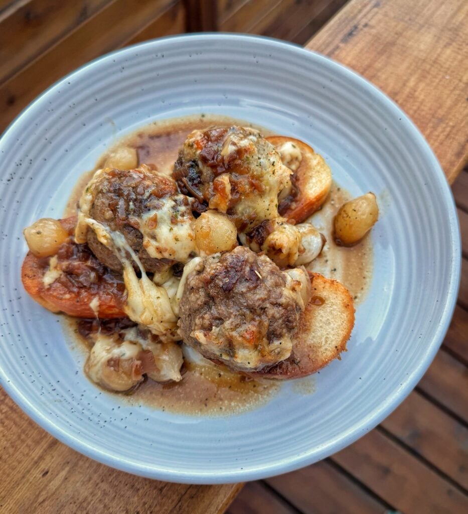 The finished meatballs over toasted bread on a plate
