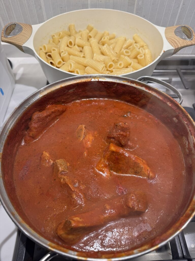 Pasta and pork chops with sauce in the pot