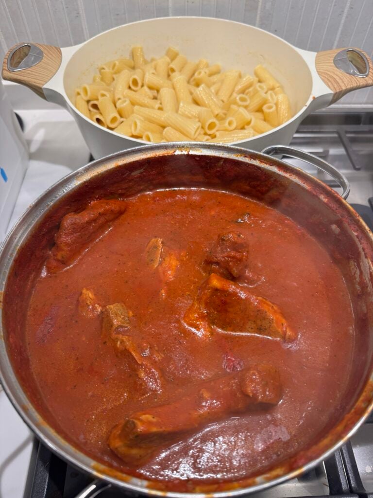 Pasta and pork chops with sauce in the pot