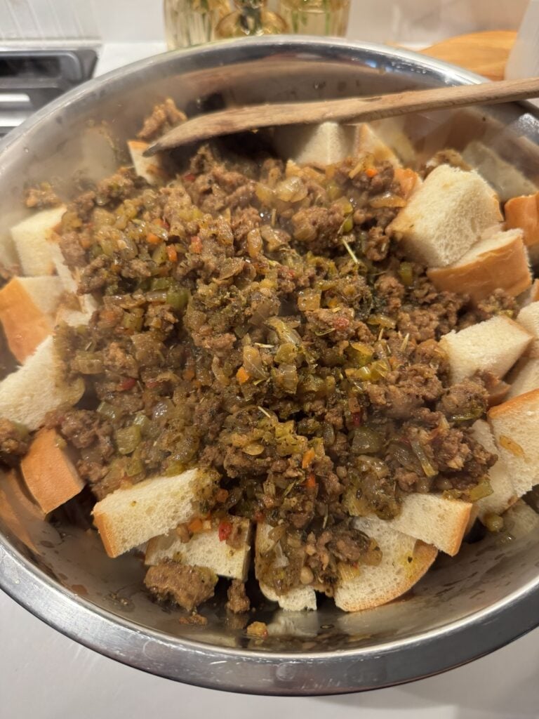 The bread soaking in the sausage and veggie mixture