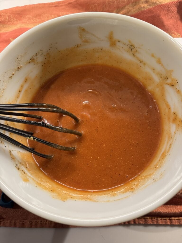 Tomato soup with a whisk