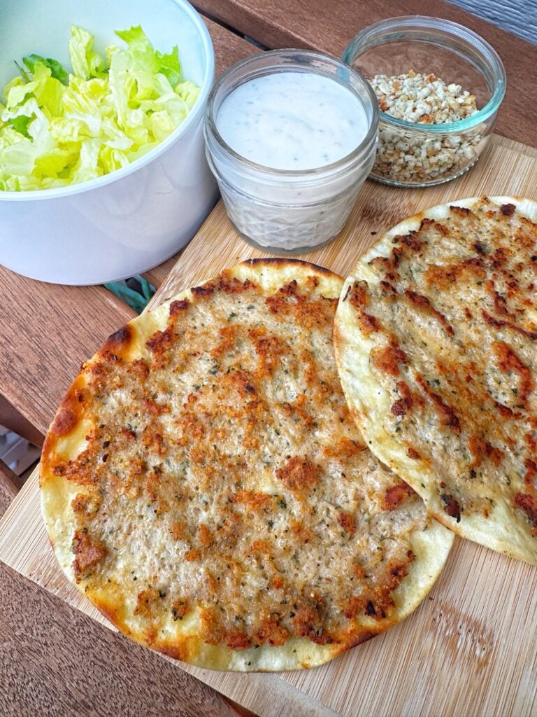 The finished tacos with dressing, crouton crumble, and chopped lettuce on the side