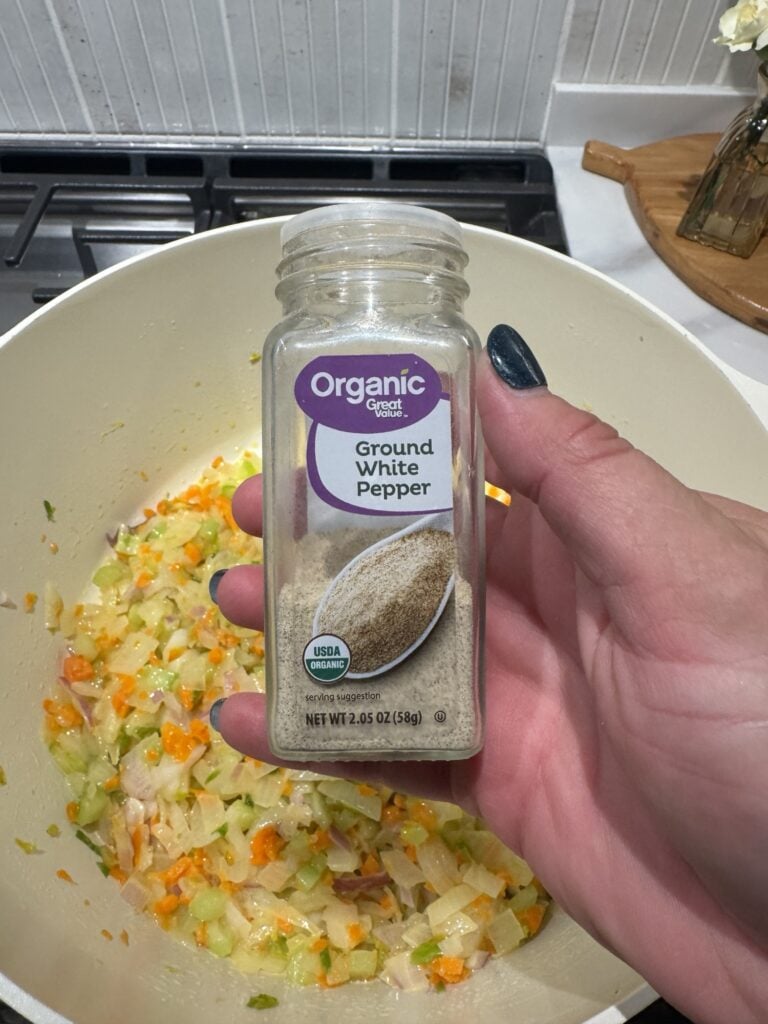 A shaker of ground white pepper