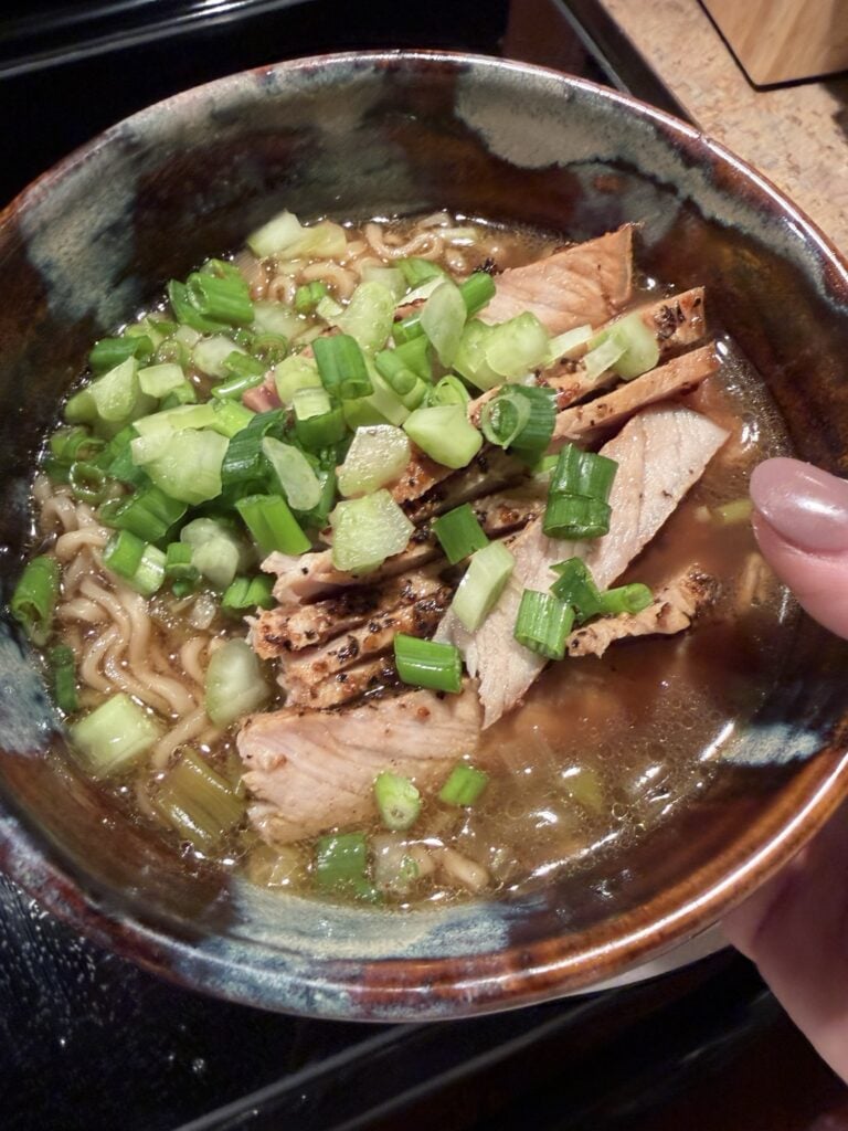 A bowl of the finished soup topped with chopped green onions