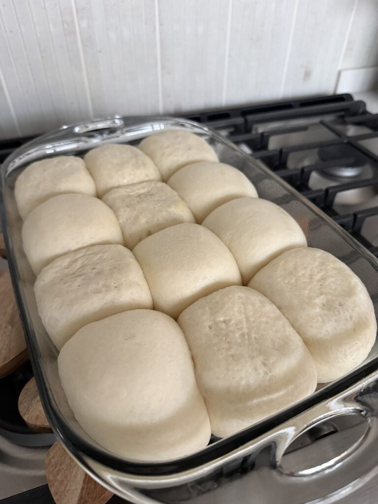Rhodes butter rolls in a baking dish before being baked