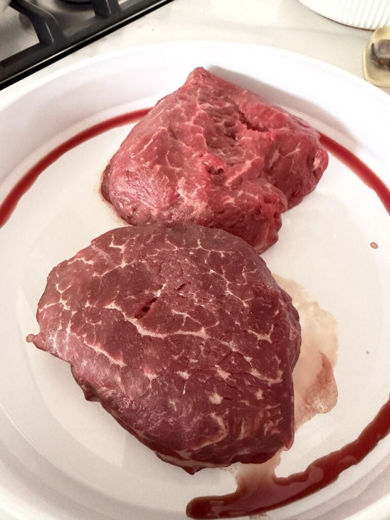 The steaks before being cooked