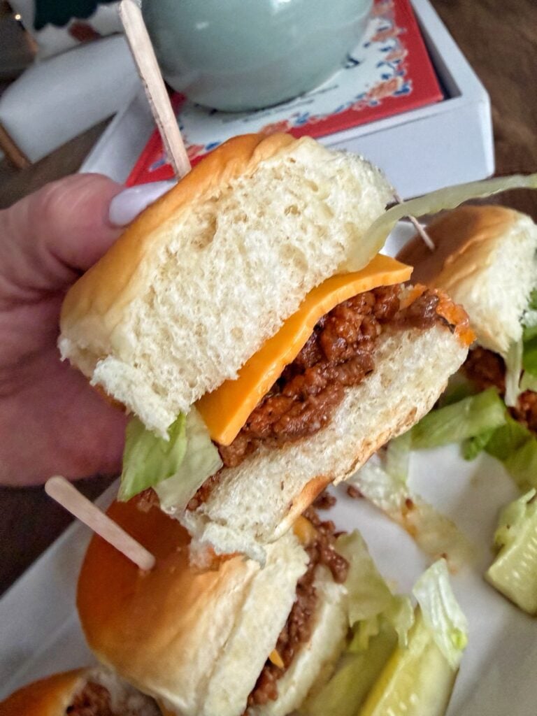 A finished sloppy joe being held