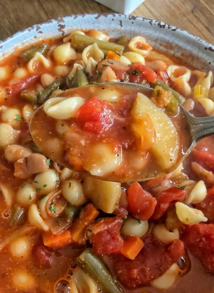 A spoon of minestrone soup