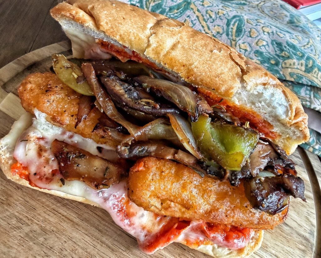 The final sandwich brimming with mozzarella sticks and veggies