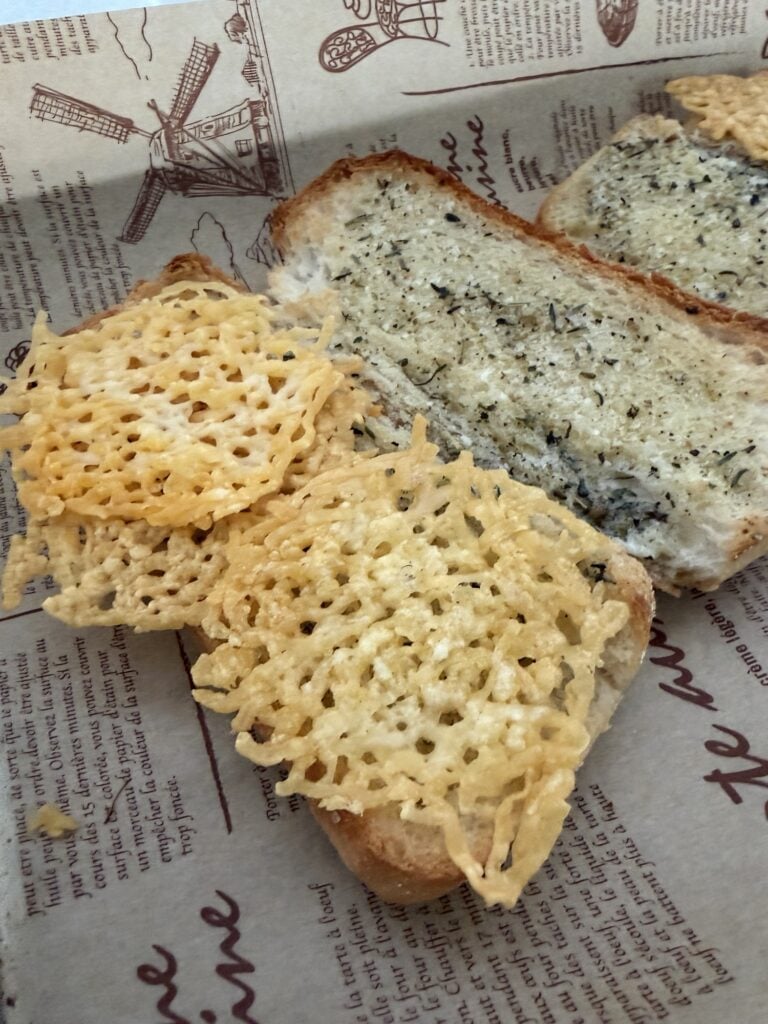 Baked Asiago cheese crowns on the bread