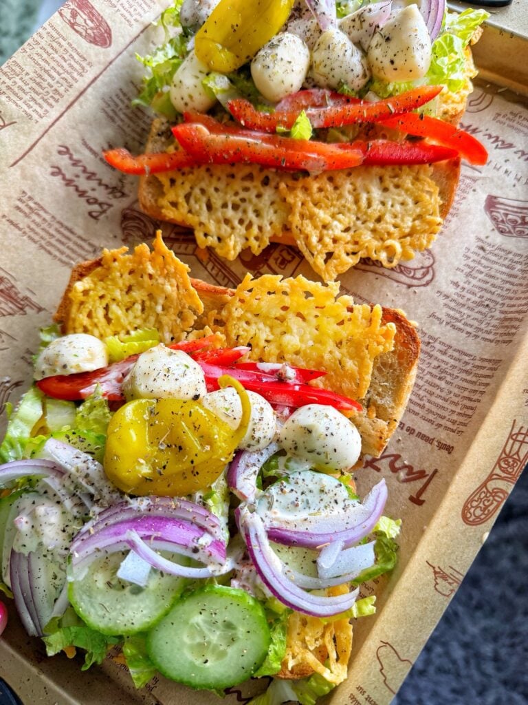 An open sub with cheese and various veggies