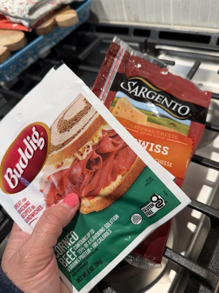 A package of Buddig corned beef and a package of Swiss cheese