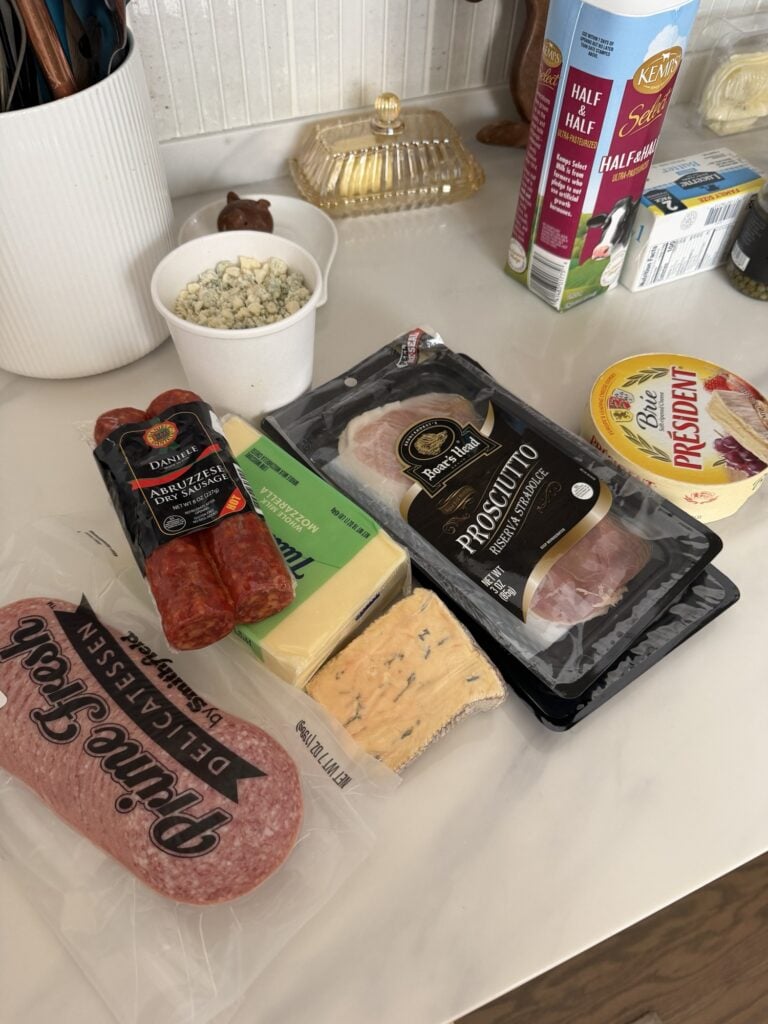 The ingredients for the nachos, including prosciutto, sausage, salami, and various cheeses