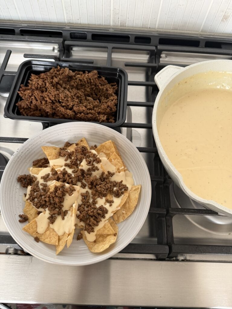 The chips topped with cheese sauce and ground beef
