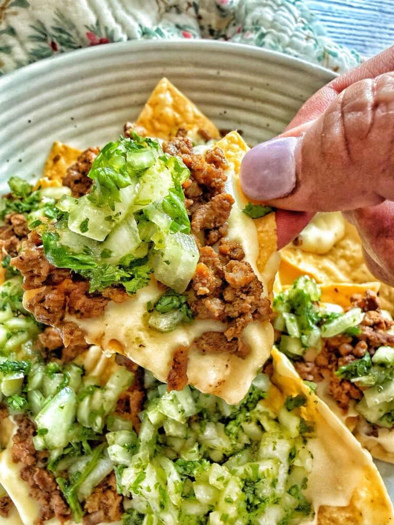 A chip with all of the nacho toppings