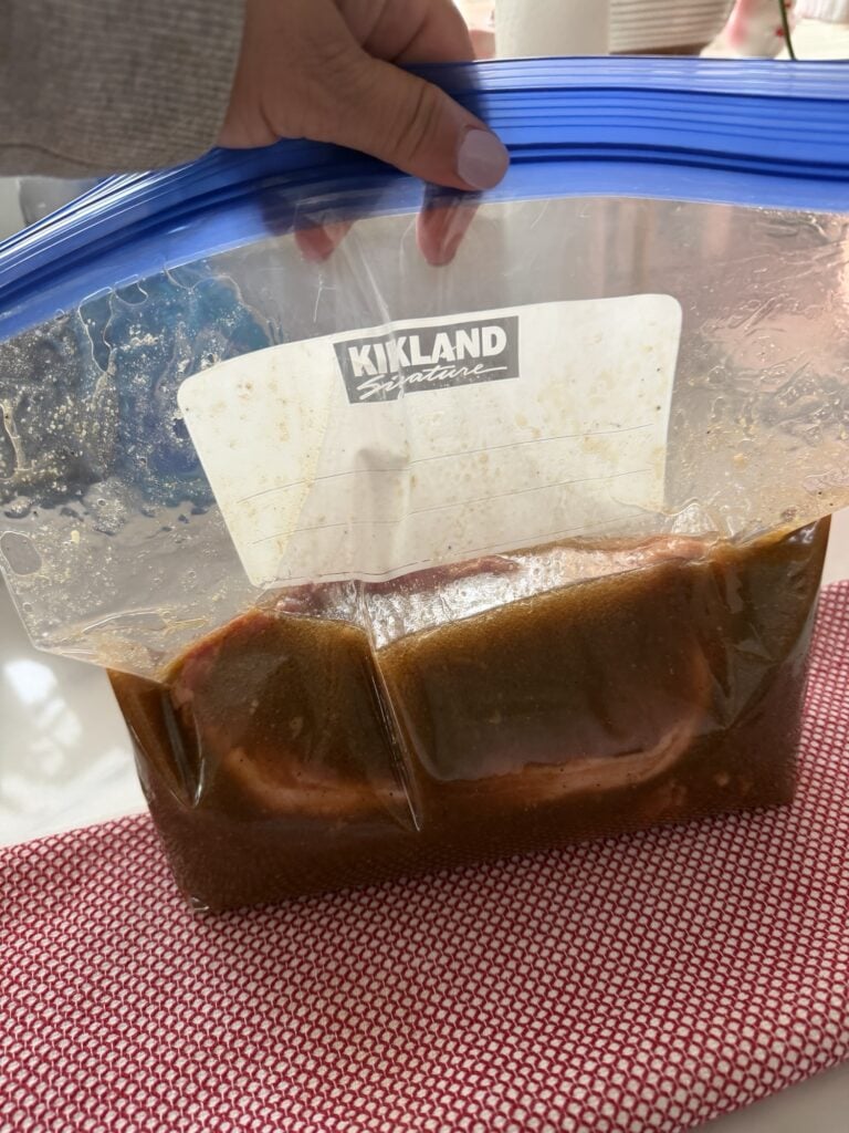 The meat in a marinade in a plastic bag