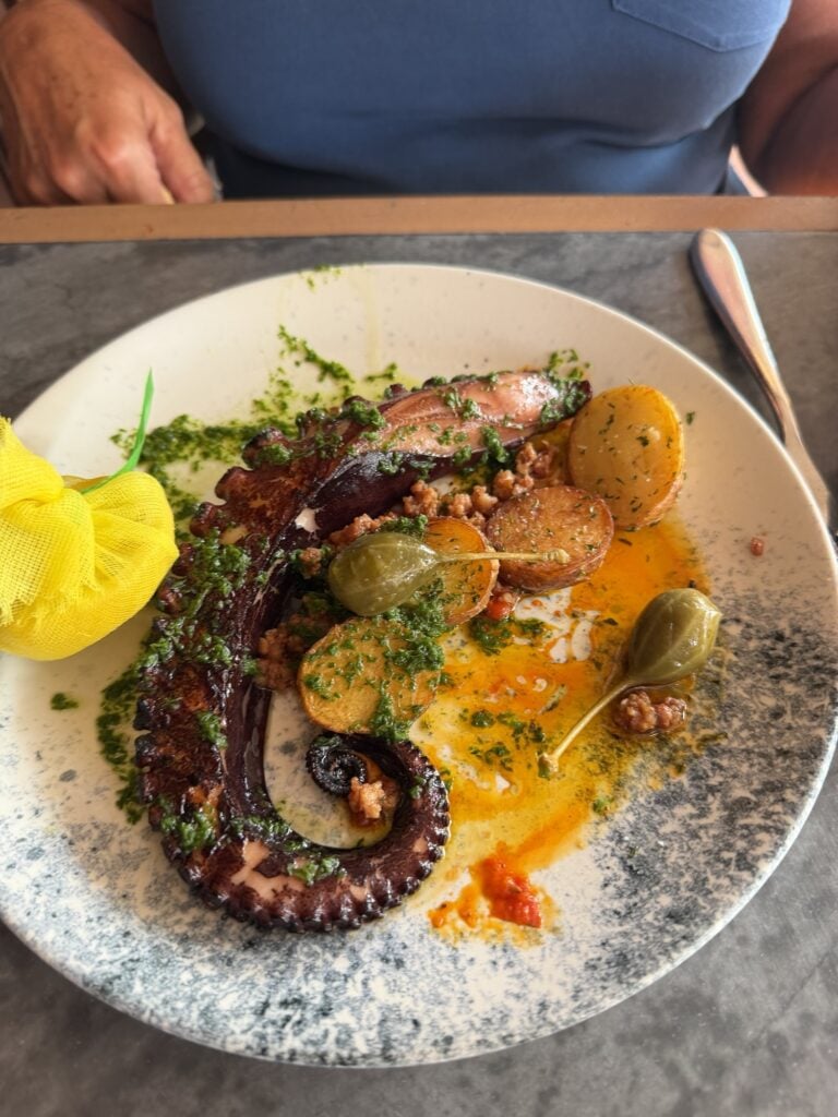 An octopus dish with potatoes and and large capers