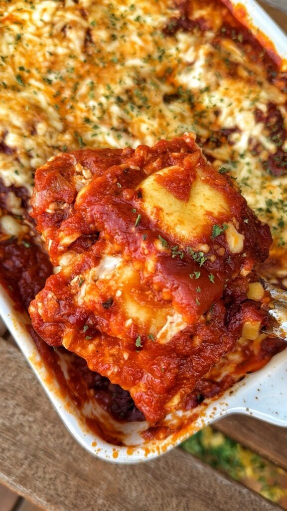 A close up of a spoon of the finished ravioli bake