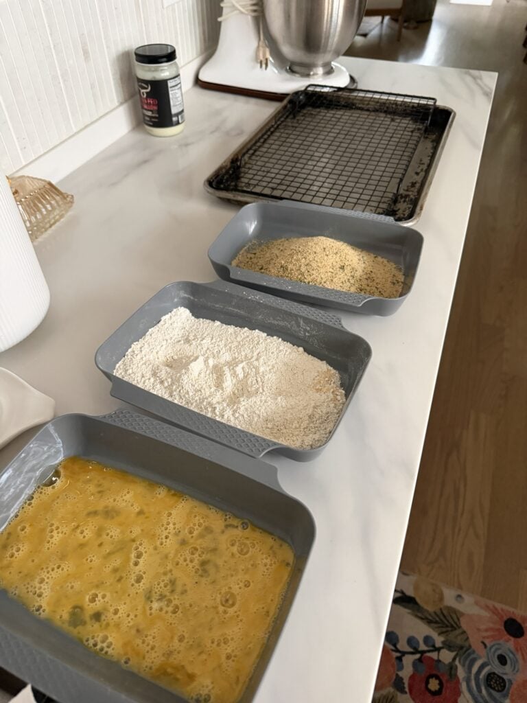 The breading station, with pans of egg, flour, and breadding