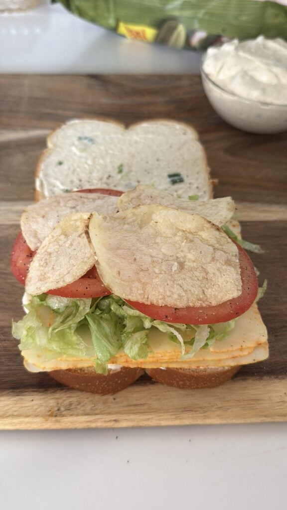 The sandwich, open to show the layer of chips on the top