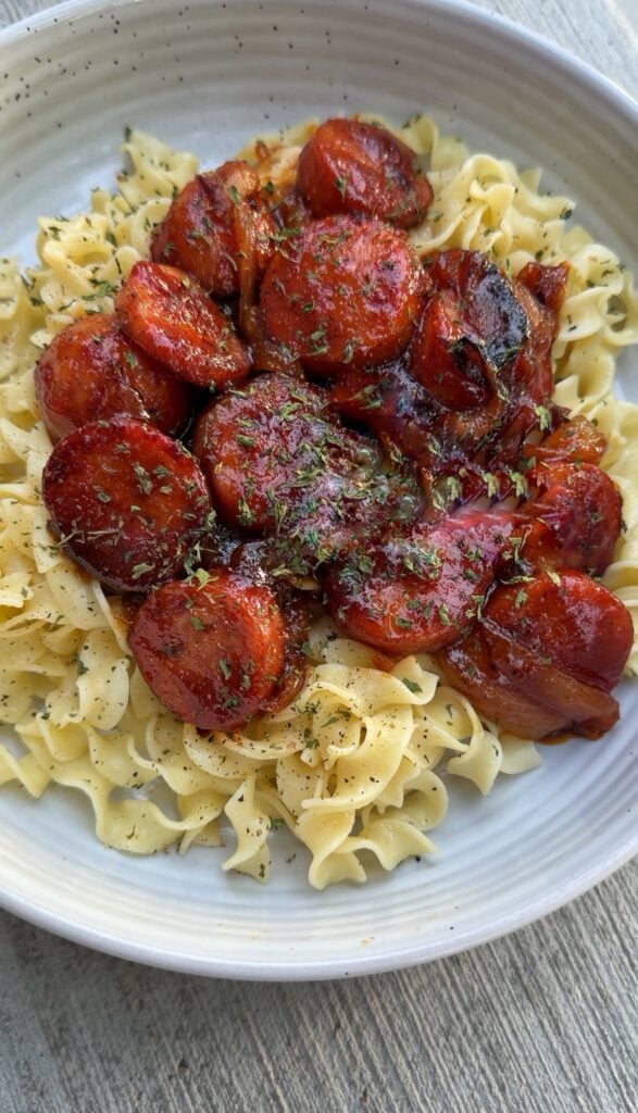 Garlic & Brown Sugar Skillet Sausage and Onions Over Buttered Egg Noodles