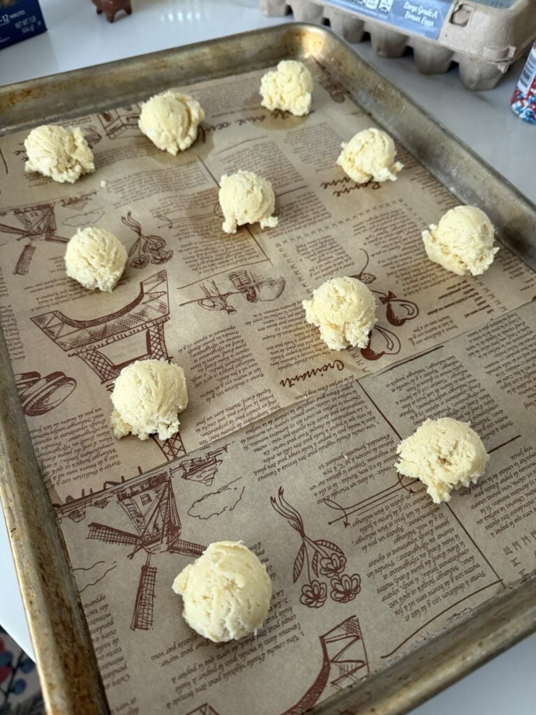 The cookie dough scoops on a baking sheet