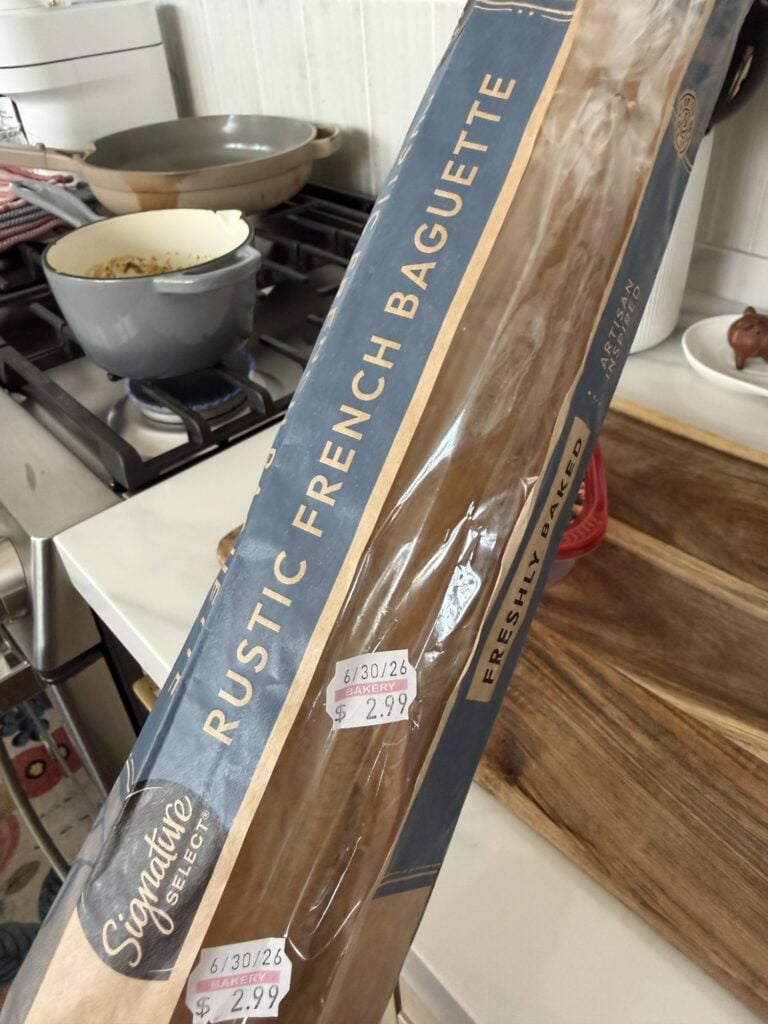 A freshly baked baguette in a bag