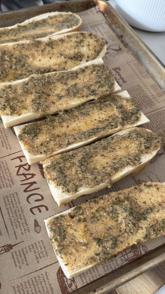 The Dijon butter spread on baguette loaves