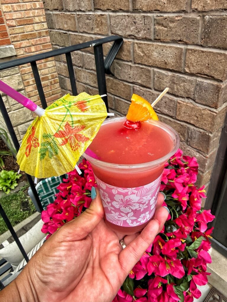 The finished drink topped with orange, cherry, and a mini umbrella