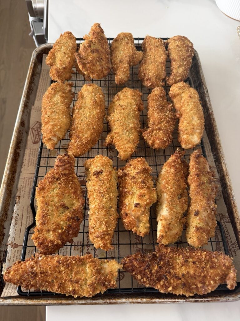 Breaded chicken tenders on a baking rack